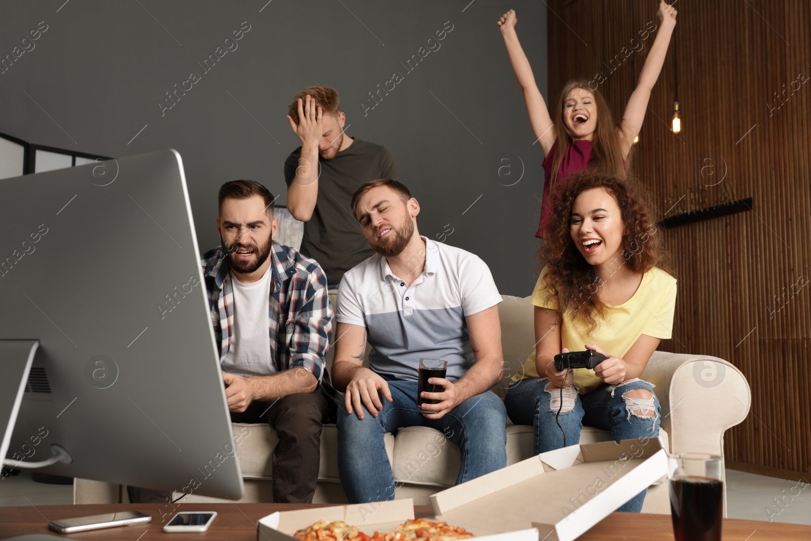 Photo of Emotional friends playing video games at home