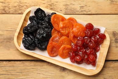 Photo of Delicious dried fruits on wooden table, top view