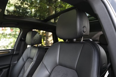 Clean leather seats inside of modern black car