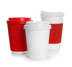 Photo of Takeaway paper coffee cups with lids on white background. Space for design