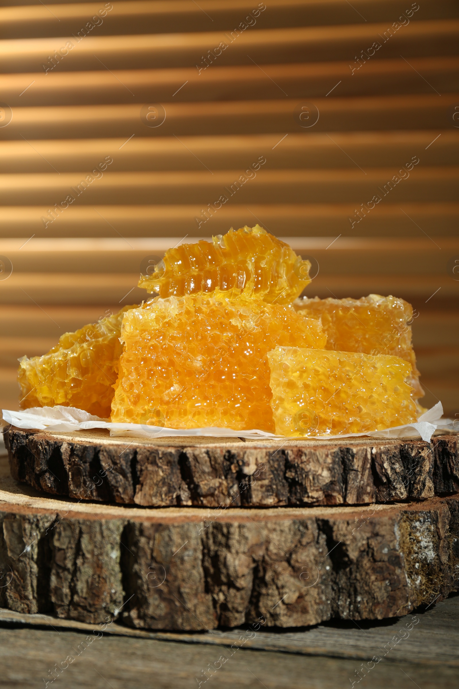 Photo of Natural honeycombs on rustic table, closeup. Space for text