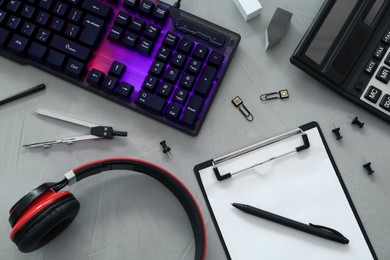 Photo of Flat lay composition with modern RGB keyboard on grey table