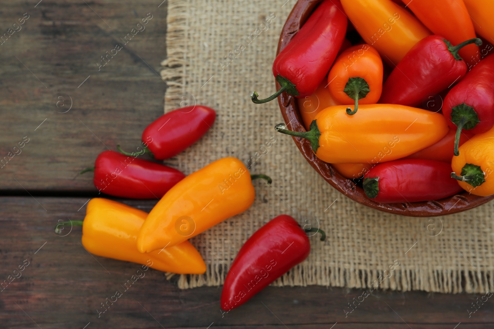 Photo of Ripe bell peppers on wooden table, flat lay