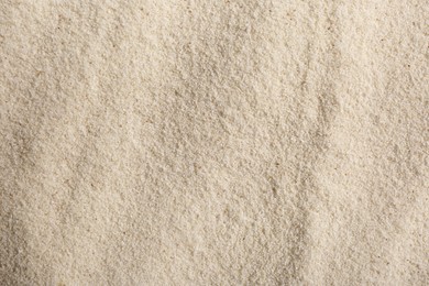 Photo of Uncooked organic semolina as background, closeup view