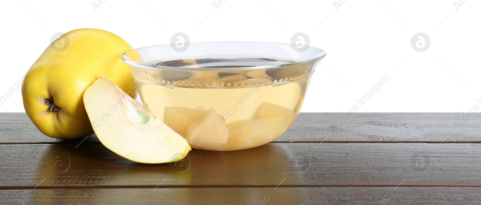 Photo of Delicious quince drink and fresh fruits on wooden table against white background