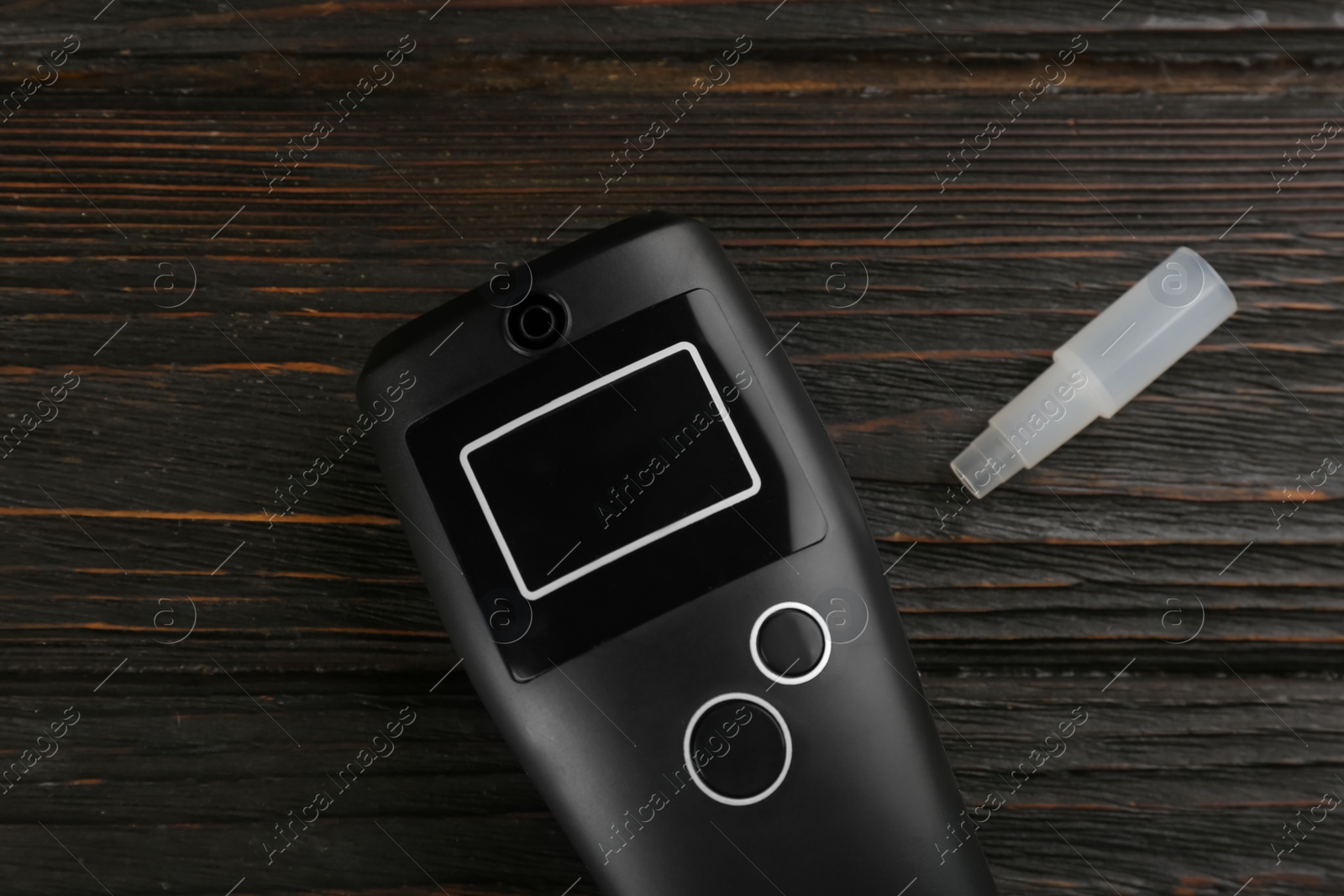 Photo of Modern breathalyzer and mouthpiece on dark wooden background, flat lay