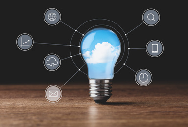 Image of Cloud technology concept. Light bulb with sky and different icons