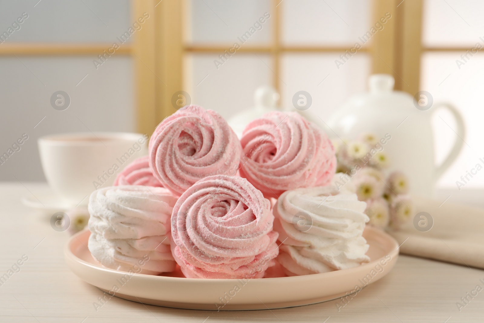 Photo of Plate with delicious marshmallows on wooden table