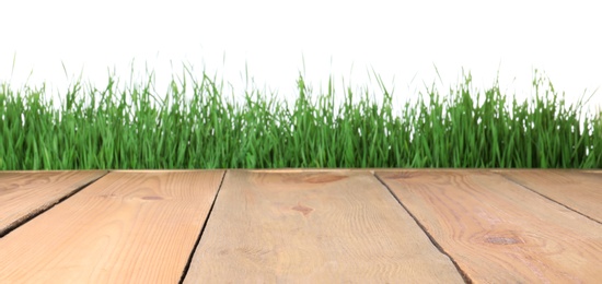 Photo of Wooden deck and green grass isolated on white