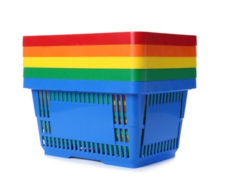 Photo of Colorful plastic shopping baskets on white background