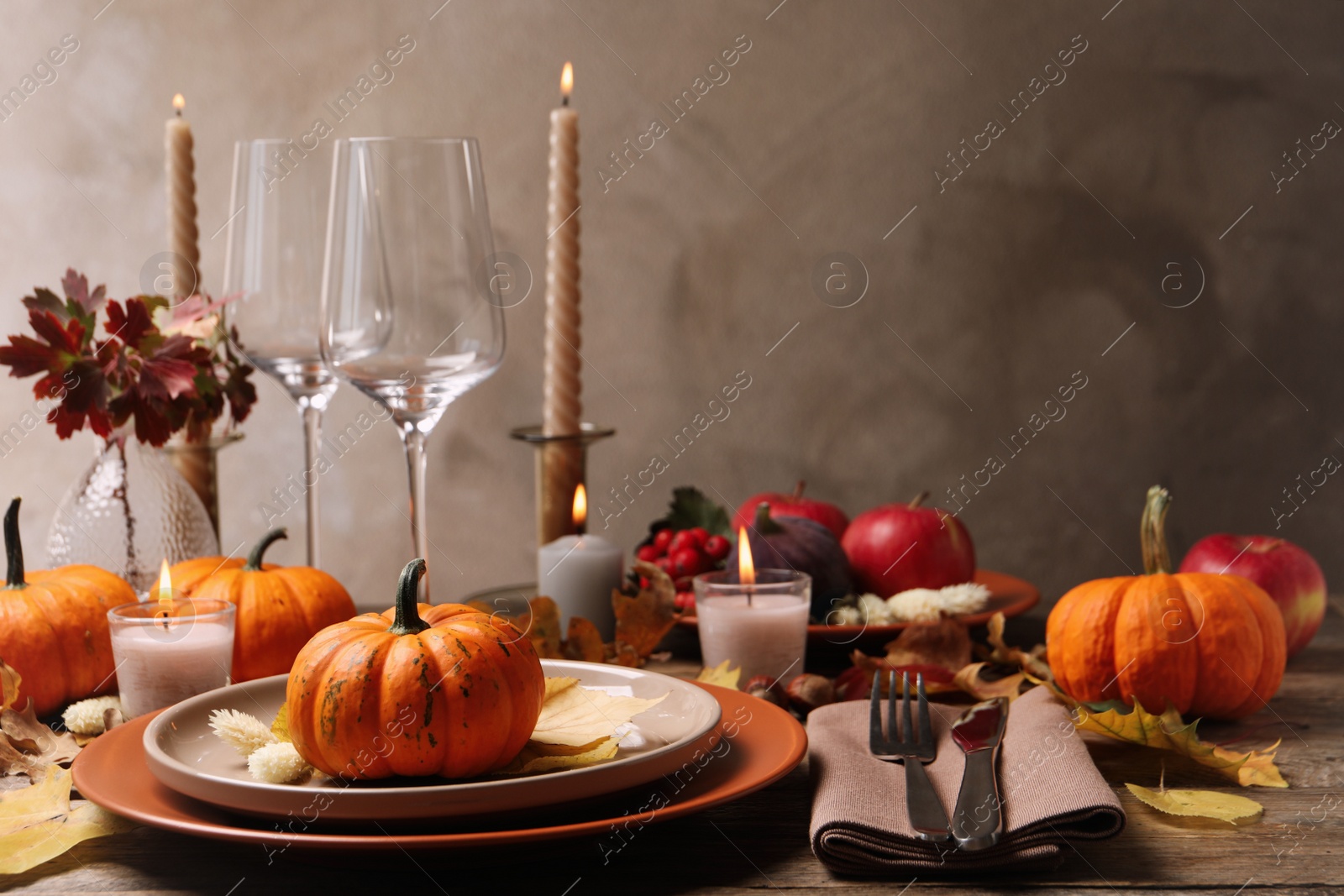 Photo of Beautiful autumn place setting and decor on wooden table, space for text