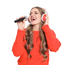 Happy young woman singing into microphone on white background. Christmas music