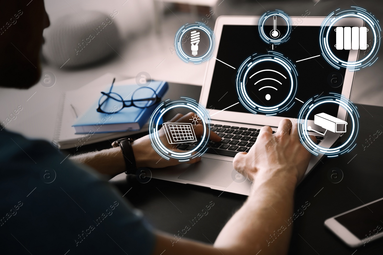 Image of Man using laptop to control smart home, closeup. Automatic systems