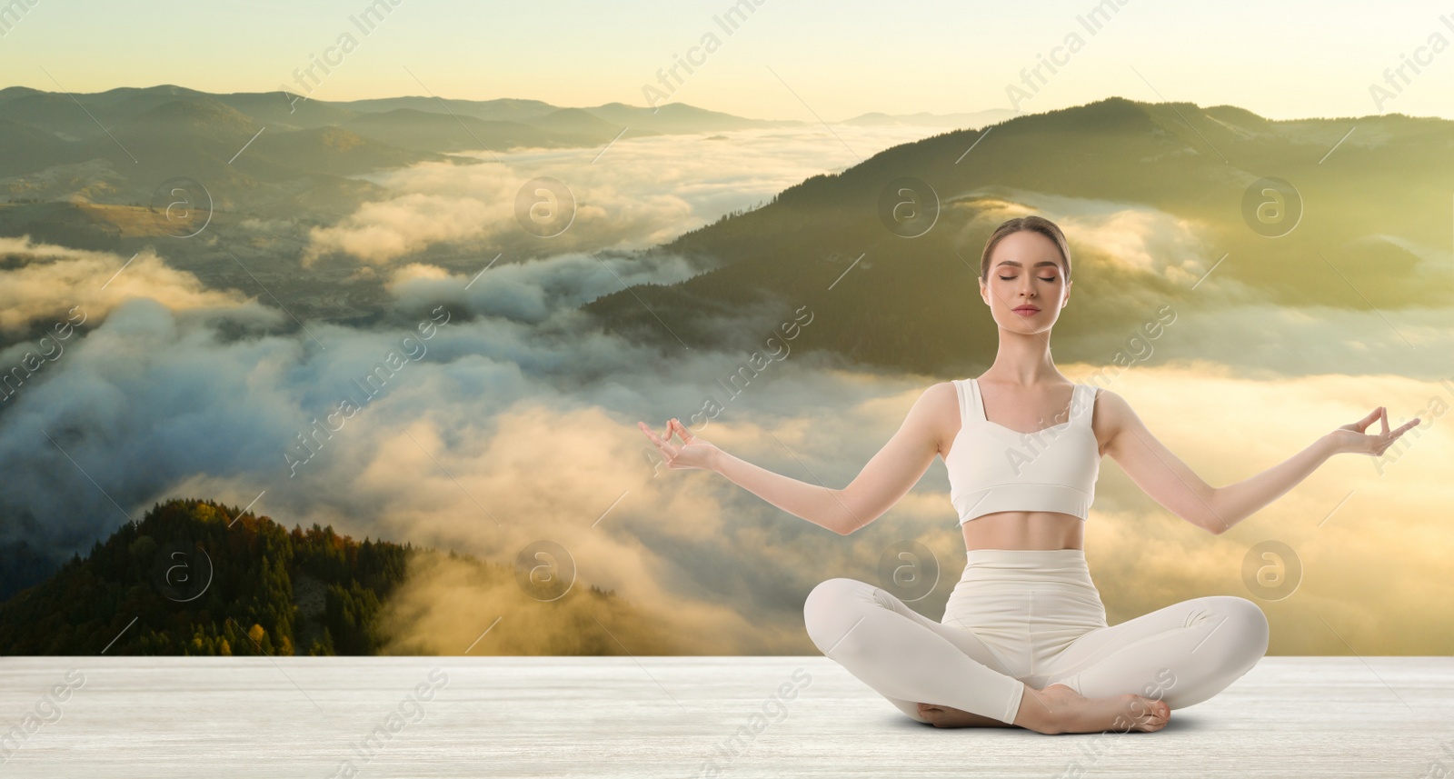 Image of Young woman practicing yoga on white wooden surface against beautiful mountain landscape, space for text. Banner design