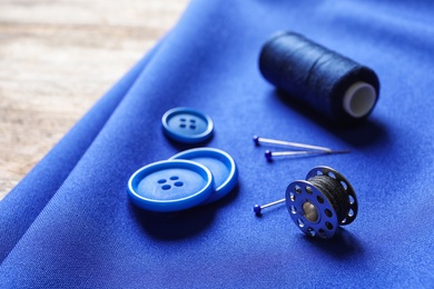 Photo of Set of tailoring accessories on blue fabric