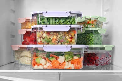 Photo of Boxes with different products inside of refrigerator