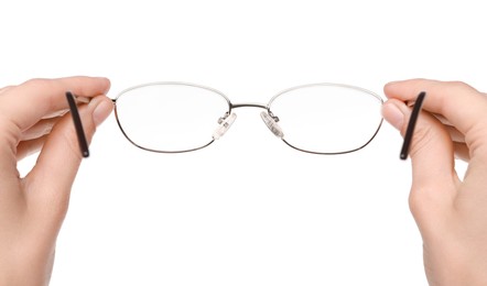 Photo of Woman holding stylish glasses with metal frame on white background, closeup