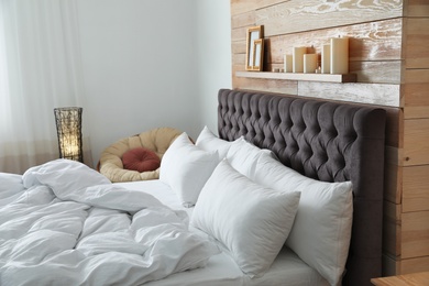 Large comfortable bed in stylish room. Modern interior design