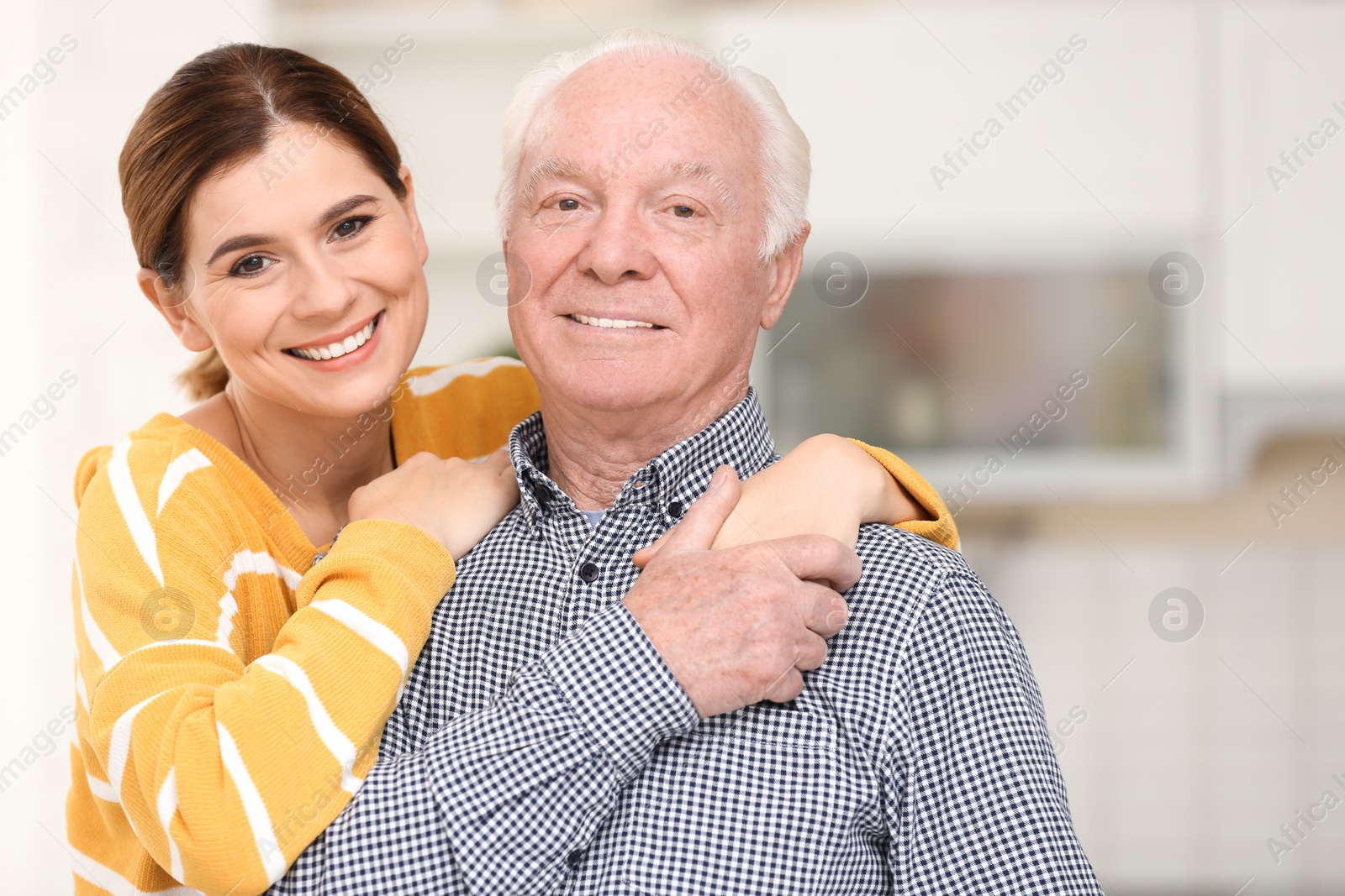 Photo of Elderly man with female caregiver in kitchen
