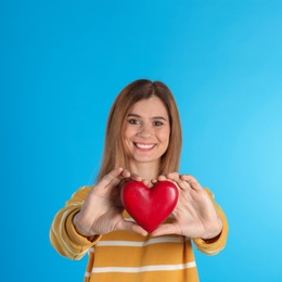 Photo of Portrait of woman with decorative heart on color background
