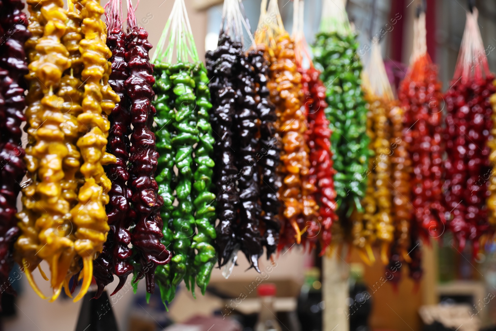 Photo of Bunches of different delicious churchkhelas at market, space for text