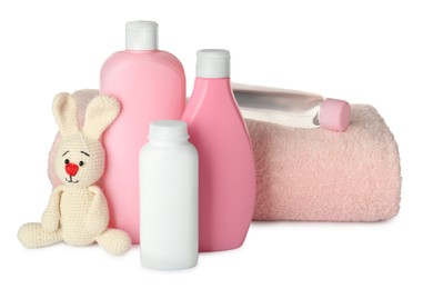 Photo of Bottles of baby cosmetic products, towel and toy bunny on white background