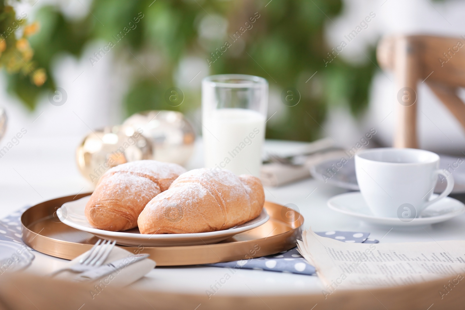 Photo of Tasty breakfast with fresh croissants on table