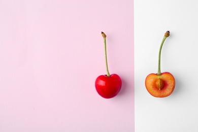 Flat lay composition with ripe red cherries on color background