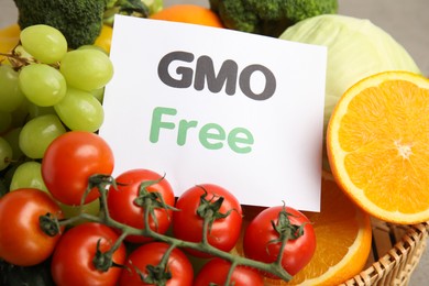 Photo of Tasty fresh GMO free products and paper card, closeup