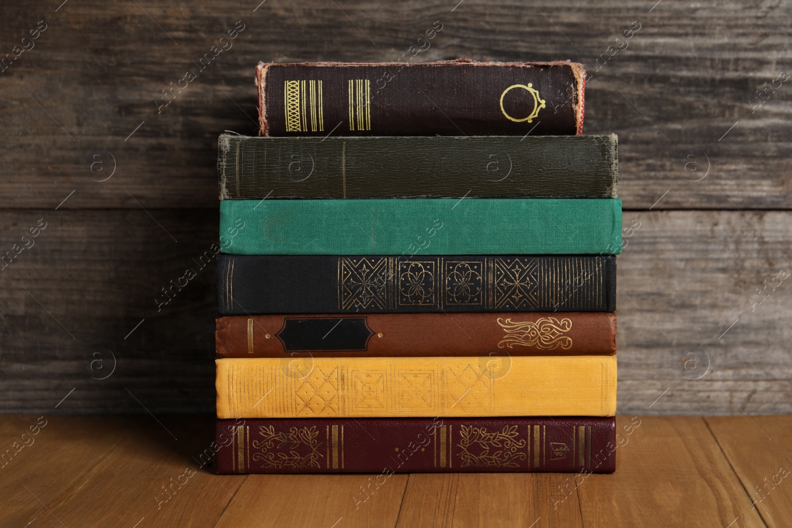 Photo of Stack of old hardcover books on wooden table