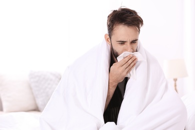 Ill man suffering from cough at home