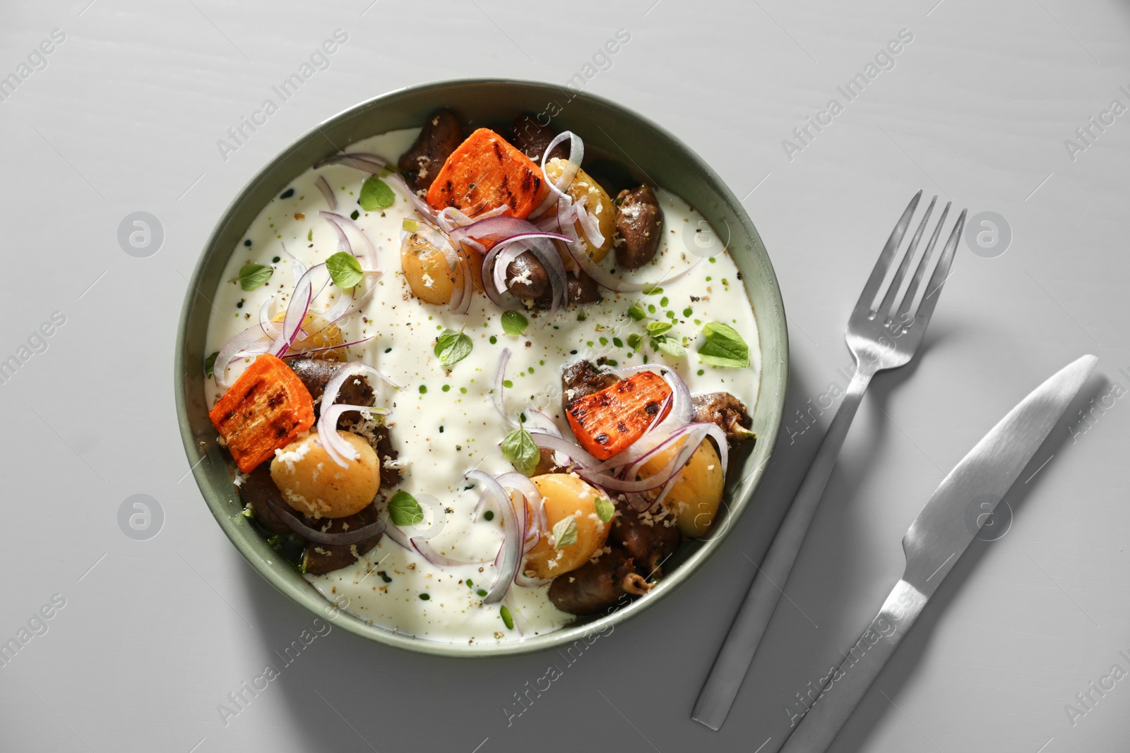 Photo of Tasty dish served on light table, flat lay