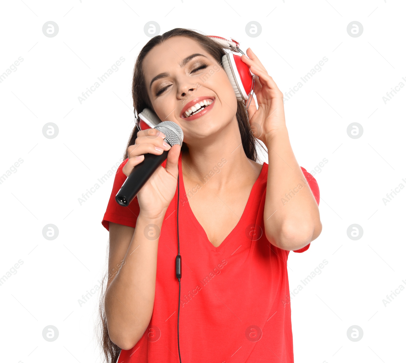 Photo of Young woman singing into microphone on white background. Christmas music