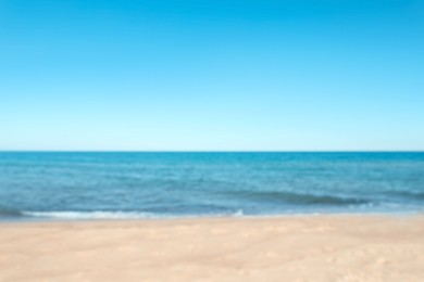 Blurred view of sandy beach near sea