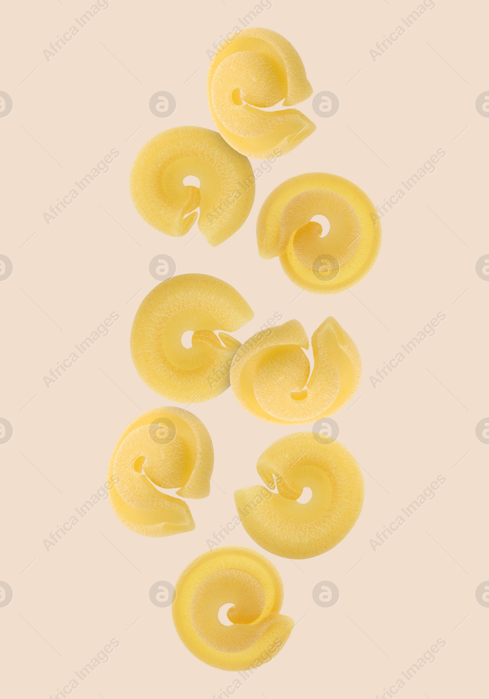 Image of Raw dischi volanti pasta flying on beige background