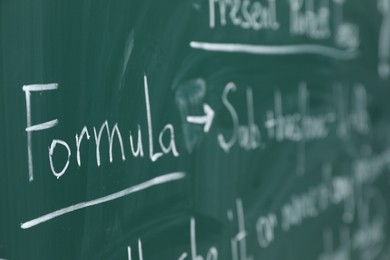 Photo of English grammar rules written with chalk on green board