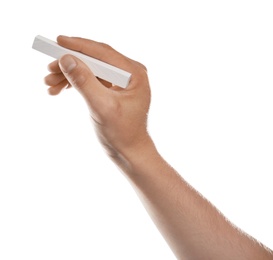 Man holding piece of chalk on white background