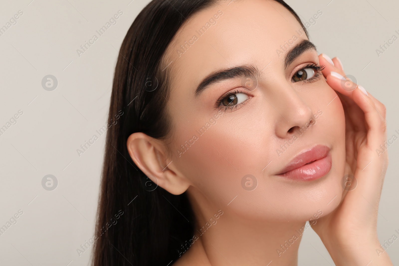 Photo of Beautiful woman with healthy skin on gray background, closeup