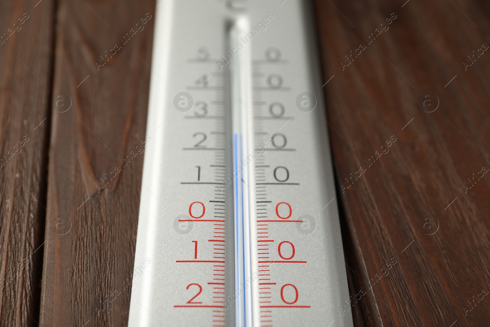 Photo of Modern weather thermometer on wooden background, closeup