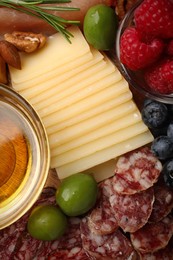 Photo of Snack set with delicious Parmesan cheese on plate, top view