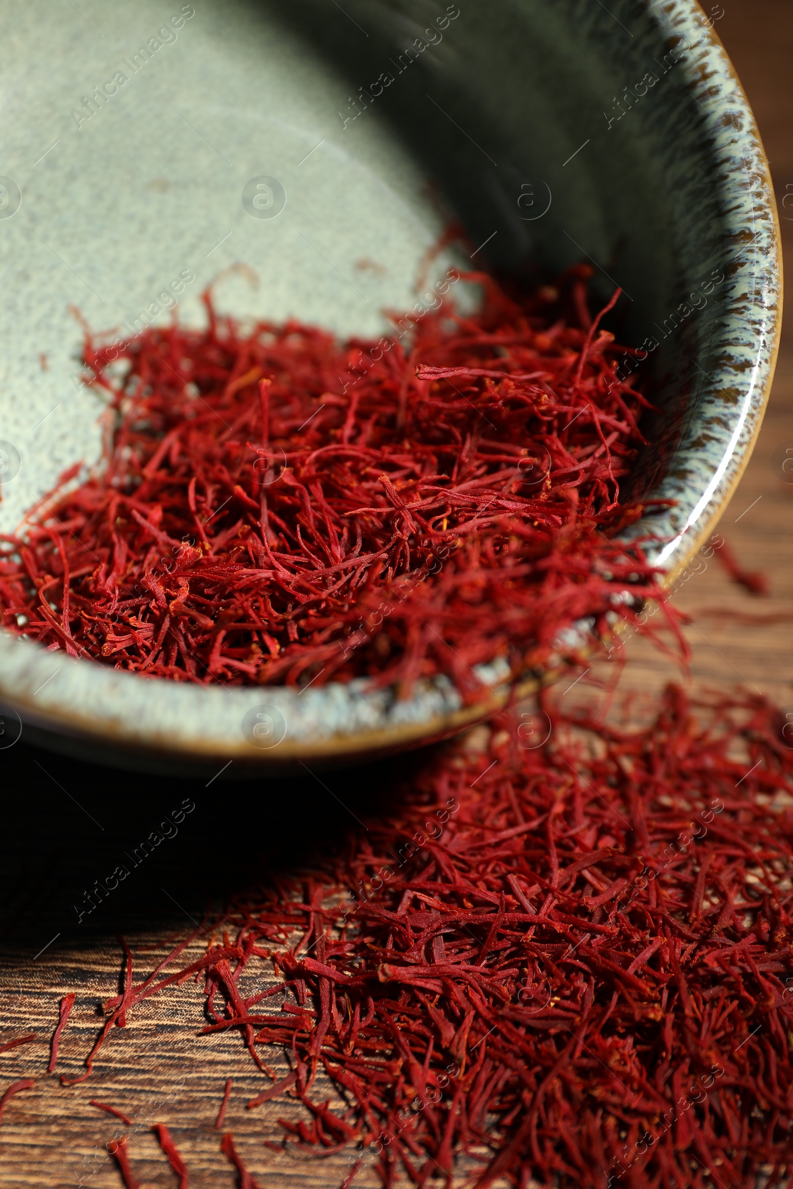 Photo of Aromatic saffron in bowl on table, closeup