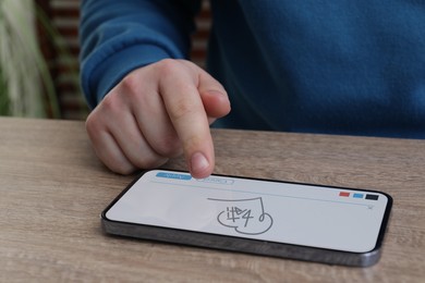 Image of Electronic signature. Man using mobile phone at wooden table, closeup