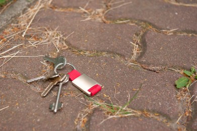 Photo of Keys on pavement outdoors, space for text. Lost and found