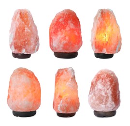 Image of Set with pink Himalayan salt lamps on white background 