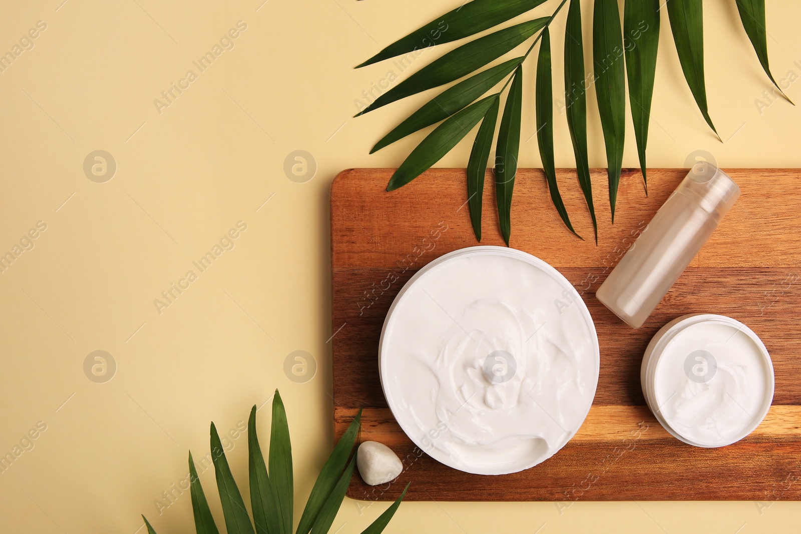 Photo of Flat lay composition with different cosmetic products on beige background. Space for text