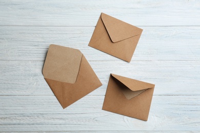 Brown paper envelopes on white wooden background, flat lay