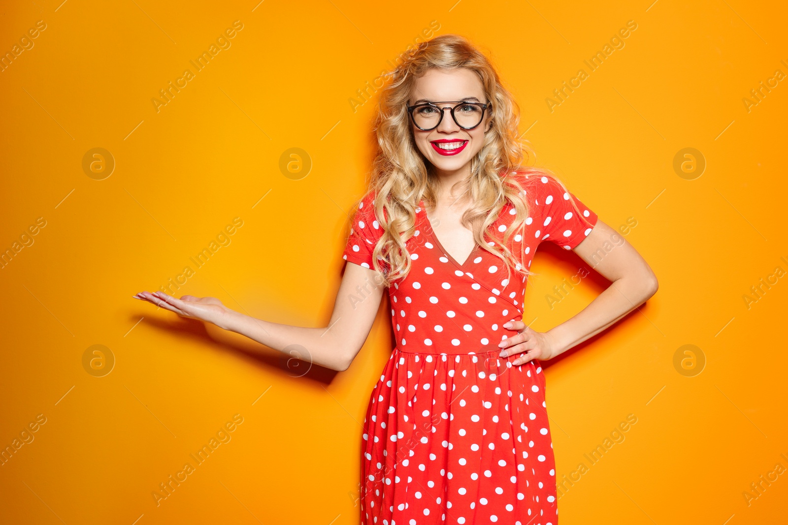 Photo of Stylish young woman posing on color background