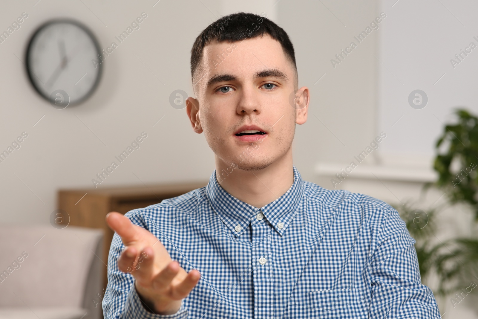 Photo of Young man having online video call at home, view from web camera