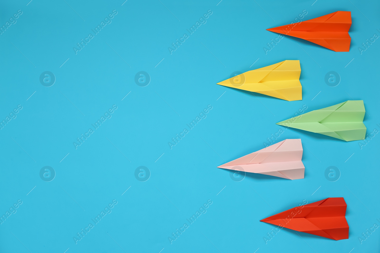 Photo of Flat lay composition with different paper planes on light blue background, space for text