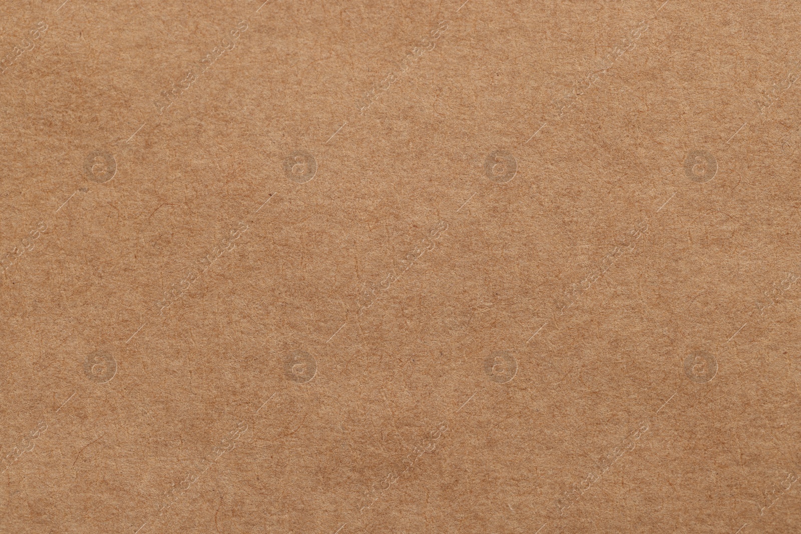 Photo of Texture of brown paper sheet as background, top view